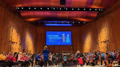A photo of the London Symphony Orchestra on the Barbican main stage before a performance