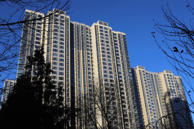 A photo of a high-rise residential building against a blue sky.