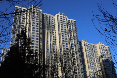 A photo of a high-rise residential building against a blue sky.