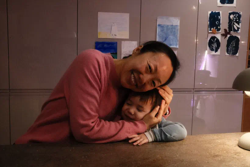 a mother hugs her son