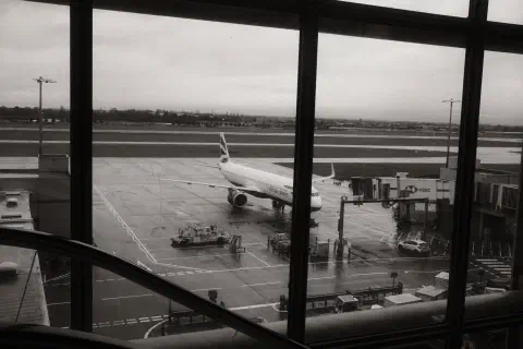 black and white photo of a British Airways plane standing at the gate