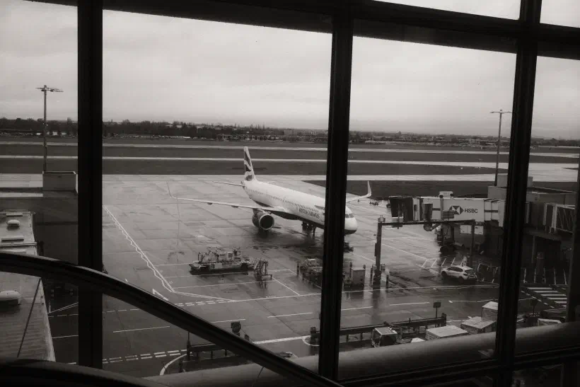 black and white photo of a British Airways plane standing at the gate