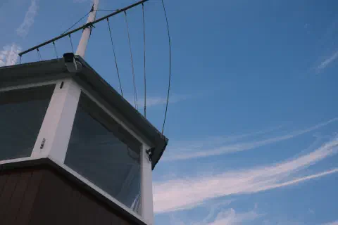 looking up at the sky, in the foreground the windows of a lookout tower