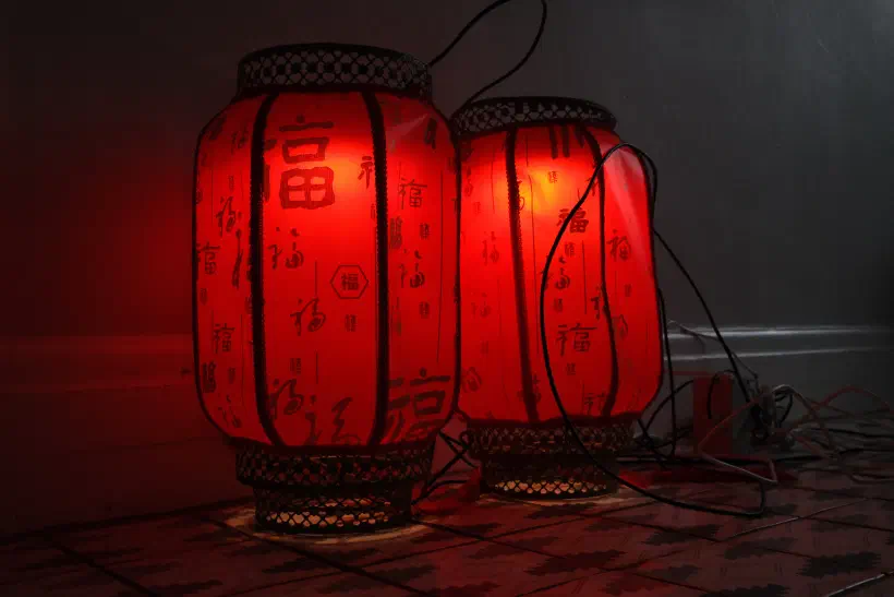 a photo of two red lanterns resting on the floor