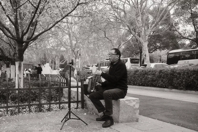 a man plays a saxophone outside nanjing zoo
