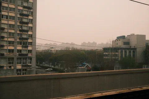 a view of residential nanjing taken from a subway platform