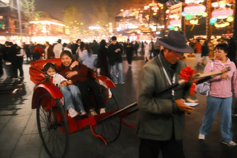 a lady and child settle in for a rickshaw ride