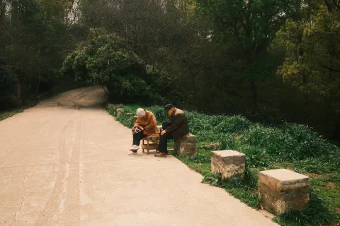 a couple rest by the side of the road leading up the mountain