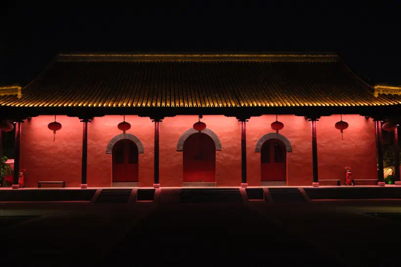 a quiet temple at night, missing the crowds present during the day