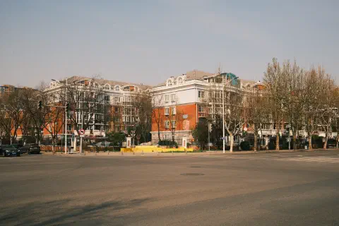 an expansive cross roads, free from traffic, looking over to residential compound