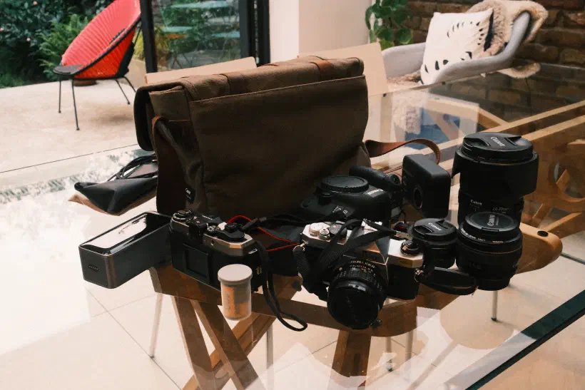 a collection of camera gear on a glass table